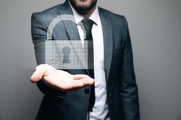 Businessman holding a virtual padlock