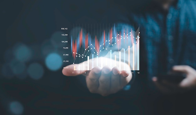 Businessman holding virtual technical graph and chart for analysis stock market technology investment and value investment concept