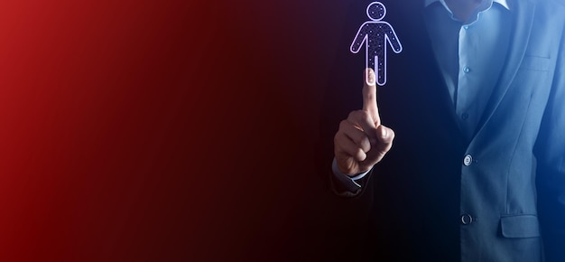 Businessman holds man person icon on dark tone background.HR Human ,people iconTechnology Process System Business with Recruitment, Hiring, Team Building. Organisation structure concept.