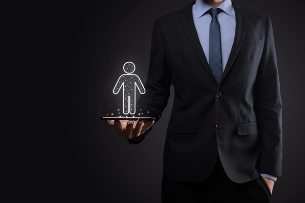 Businessman holds man person icon on dark tone wall.HR Human ,people iconTechnology Process System Business with Recruitment, Hiring, Team Building. 