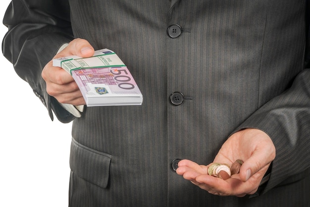 Businessman holds in one hand a bundle of euro money, and in the other a handful of coins, close-up, isolated on a white background