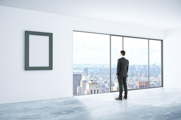 Businessman in interior with frame