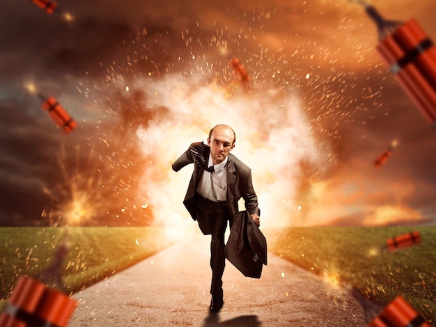 Businessman is running from dynamite exploding on the road