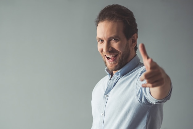 Businessman is smiling and pointing 