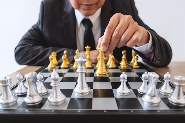 Businessman leadership playing chess and thinking strategy plan about crash overthrow the opposite team and development analyze for successful of corporate.