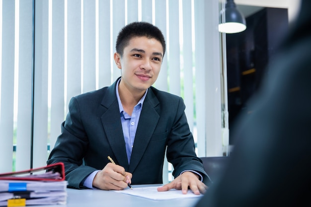 Businessman listening to candidate answers explaining about her profile, job interview concept