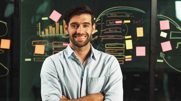 Businessman look at camera and stand with arm folded at glass wall Tracery