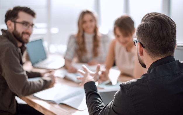 Businessman looking at the handshake of business partners