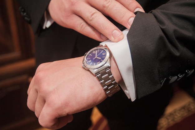 Businessman looking at his watch punctuality