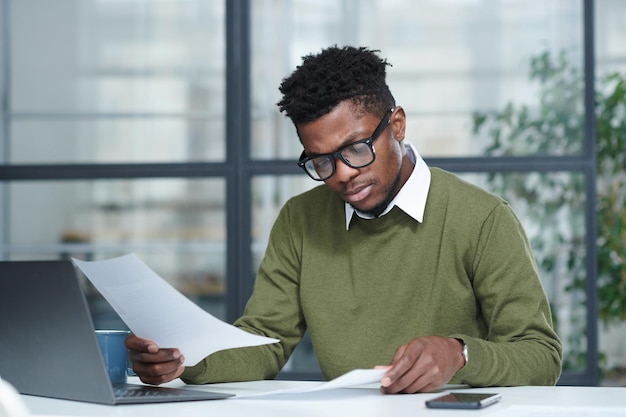 Businessman looking through the candidates resumes