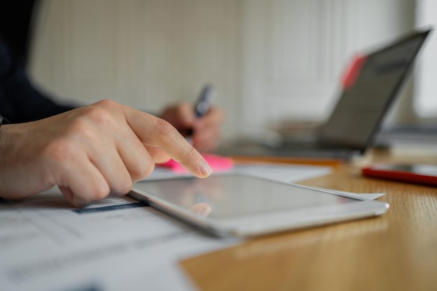 A businessman makes a report in the company's office uses a laptop