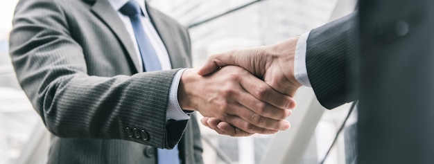 Businessman making handshake with partner