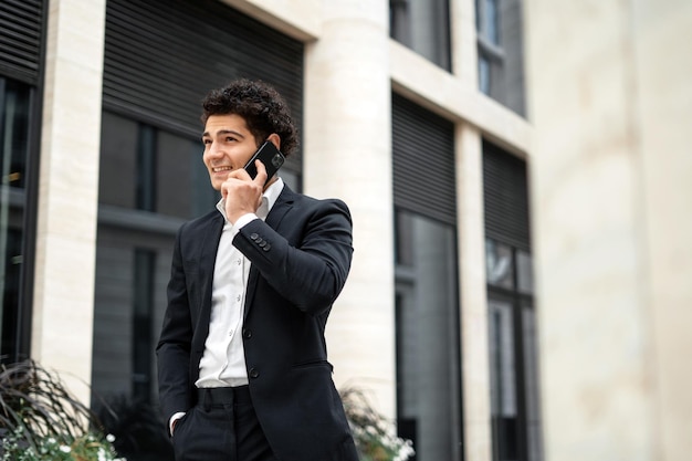 Businessman man career in a new job xA A manager in a business suit is talking on the phone