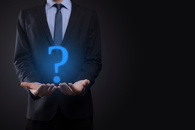 Businessman man hand hold interface question marks sign web.