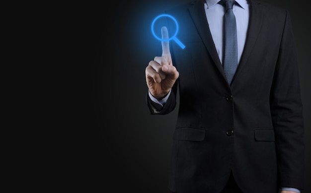 Businessman, man hold in hand magnifying glass icon.business, technology and internet concept