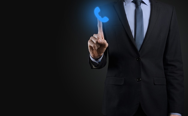 Businessman man in suit on black background hold phone icon.