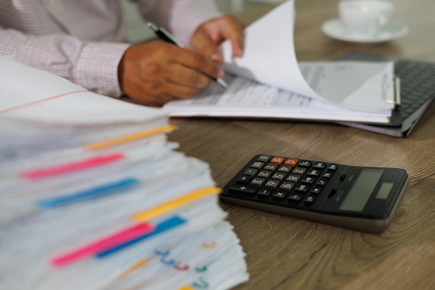 Businessman manager hands writing signing in paperwork or documentation documents on office desk