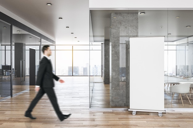 Businessman in minimalist concrete office interior