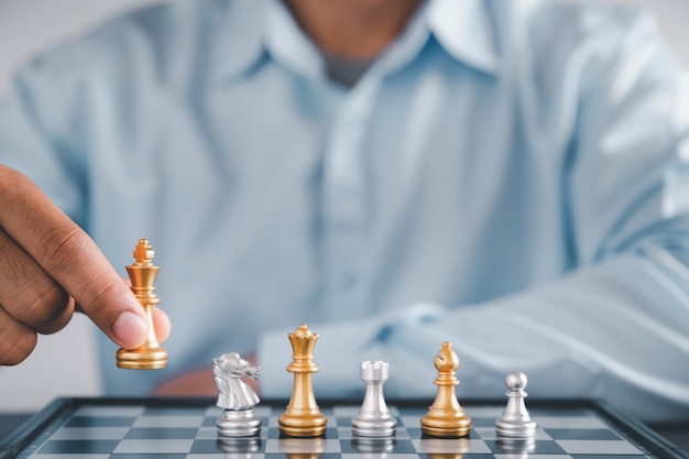 Businessman moves chess with handStrategic planning concept about mistakes topple the opposing team