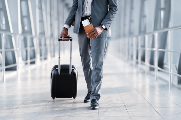 Businessman Moving To Departure Gate holding Tickets