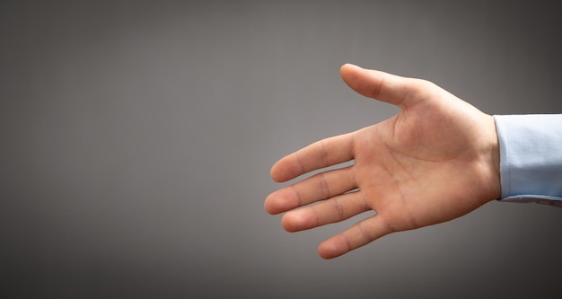 Businessman offering hand for handshake at office