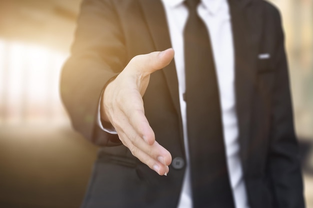 Photo businessman offering his hand for handshake in office concept of welcome for collaboration introduction selective focus