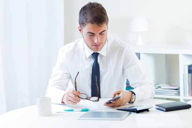 Businessman in office browsing phone