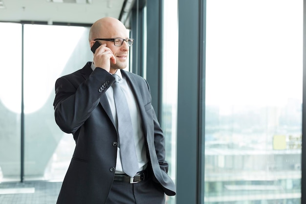 Businessman in office on cell phone