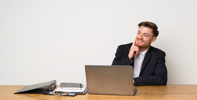 Businessman in a office thinking an idea while looking up