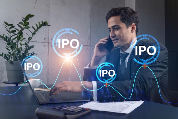 Businessman in office working with laptop technology online ipo typing computer assemble data drawing invest concept Double exposure