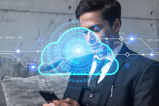 Businessman in office working with Smartphone IT Cloud hologram to optimize the working process typing phone Double exposure