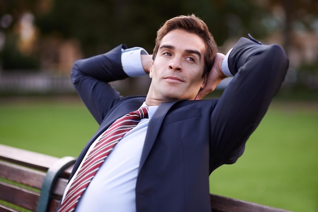 Businessman park and bench with thinking for relax idea and fresh air on sunny day in New York Corporate man and face with hands on head with confidence for vision rest or break in nature