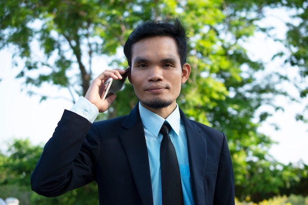 Businessman People holding Mobile Smart Phone and Talking phone