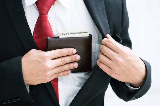 Businessman Person holding an wallet in the hands of an man taking money out of his pocket.