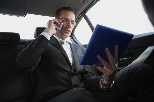 Businessman on the phone holding tablet pc