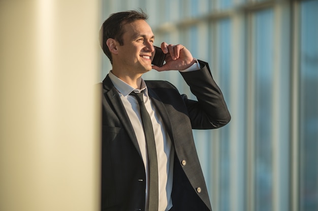 The businessman phone near the column