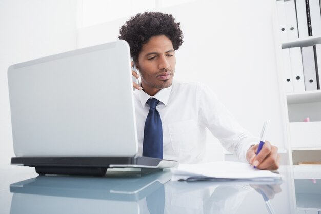 Businessman on the phone taking notes