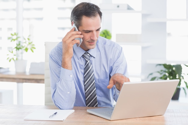 businessman phoning at his desk 