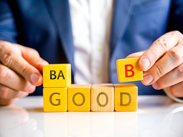 Photo businessman places wooden cubes with good and bad words business concept