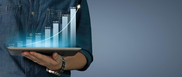 Businessman plan graph growth increase of chart positive indicators on tablet in hand