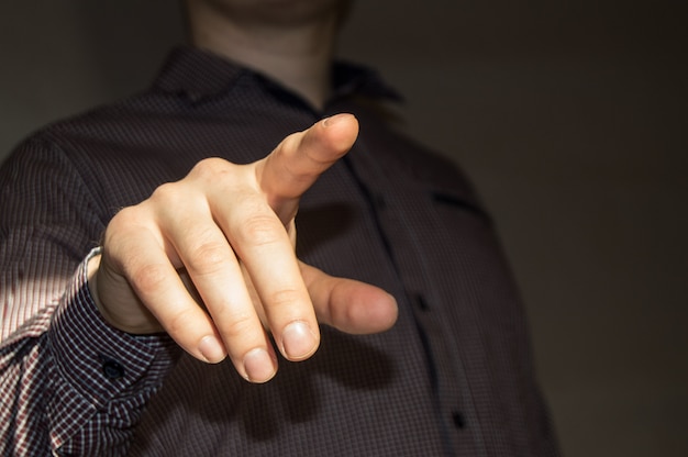 Businessman pointing finger at blank virtual screen by pressing a virtual button