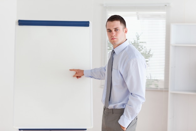 Businessman pointing at flip chart