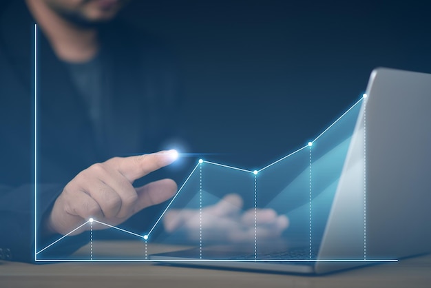 Businessman pointing graph growth and financial network connectionBusinessman touch growth graph and progress of business and analyzing financial and investment data business planning