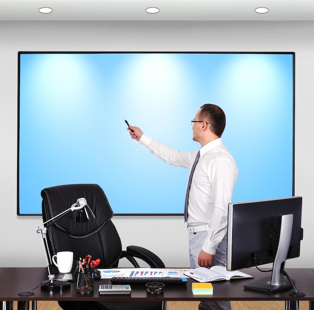 Businessman pointing to plasma panel