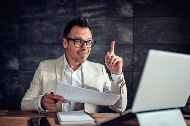 Businessman pointing up because he has a problem solution