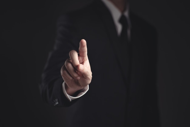 businessman presenting in black suit on black