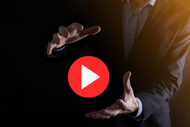 Businessman pressing, hold play button sign to start or initiate projects.Video Play Presentation. Idea for business, technology.media player button. Play icon.Go.