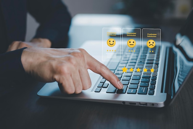 Businessman pressing smile on laptop keyboard customer service evaluation conceptrating to service experience on online application Customer review satisfaction feedback surveyNegative feedback