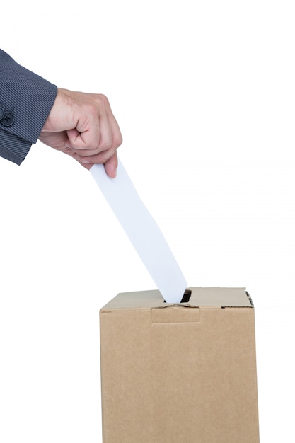 Businessman putting ballot in vote box