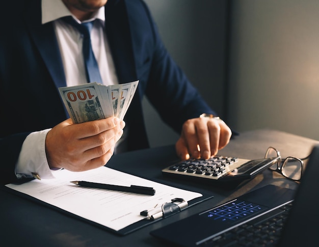 Businessman putting banknotes of dollars  in suit pocket Corruption concept with  copy space